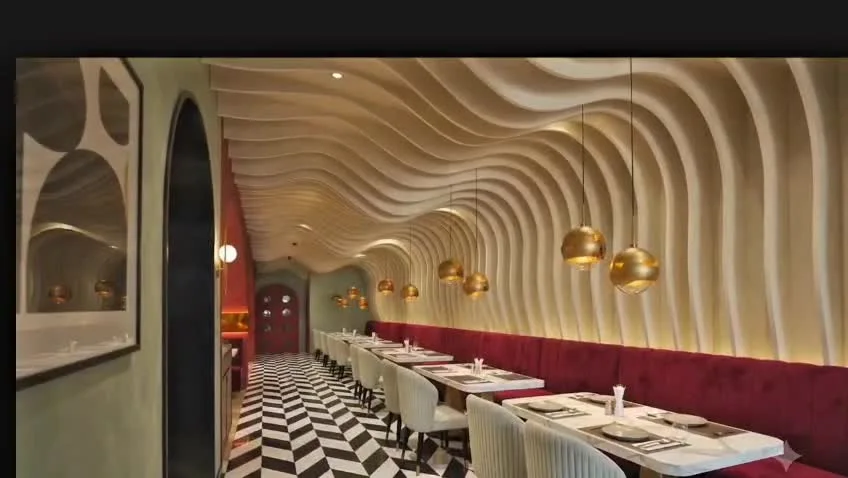 Supplied interior visualization: sculpted ivory walls, burgundy seating and warm pendant lights.